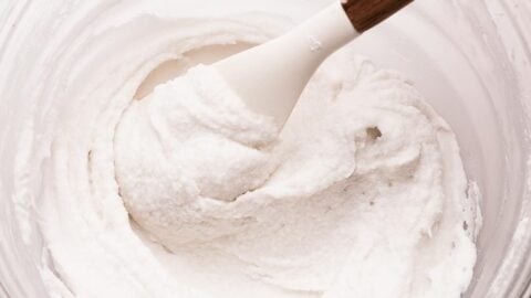 Last process of making vanilla butter free frosting in a mixing bowl.