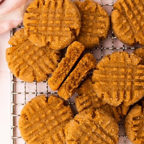 A small batch of peanut butter cookies arranged on a wire rack.