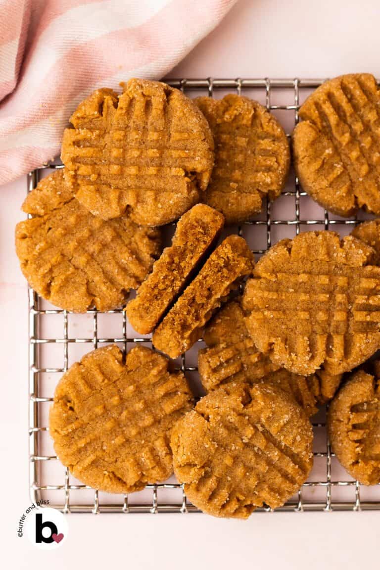 A small batch of peanut butter cookies arranged on a wire rack.