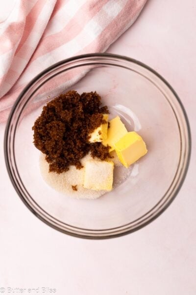 Butter and sugars in a mixing bowl, ready to be combined.