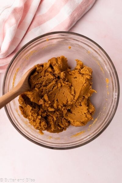 Thick peanut butter cookie dough in a mixing bowl.
