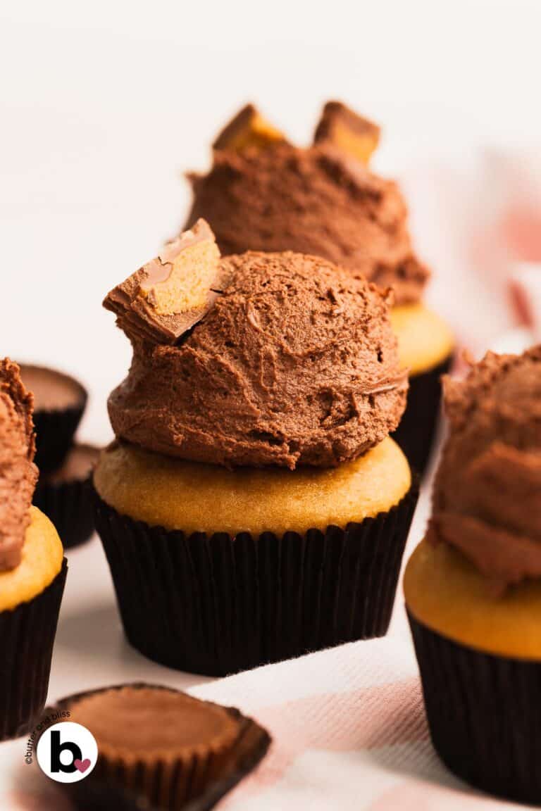 Chocolate frosted peanut butter cupcakes with a peanut butter cup candy garnish.