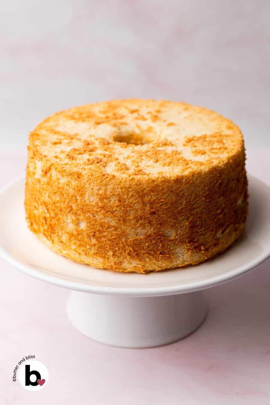 Small angel food cake on a cake stand.