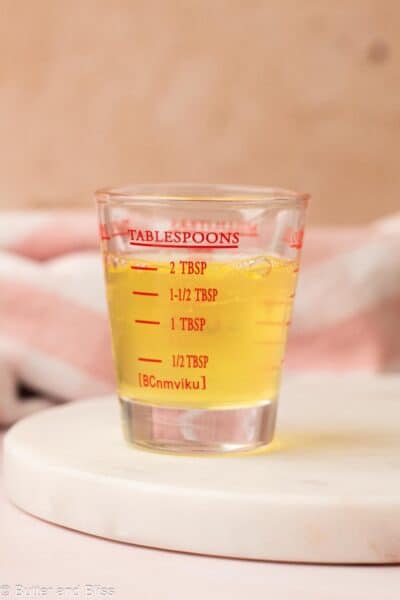 Egg white measured in a shot glass measuring cup.
