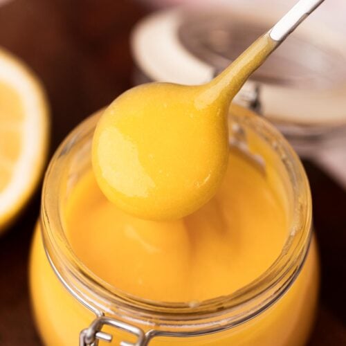 Bright lemon curd on a spoon.