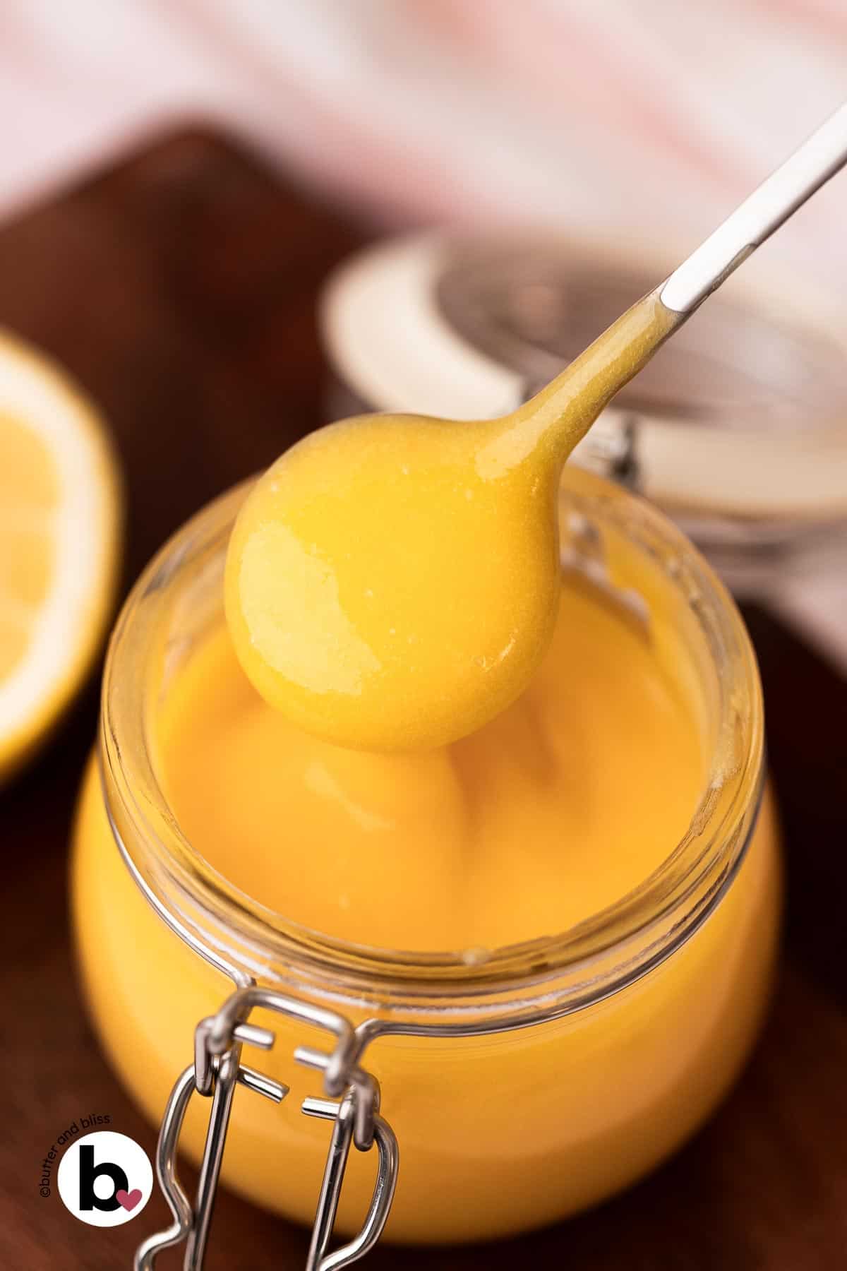 Bright lemon curd on a spoon.