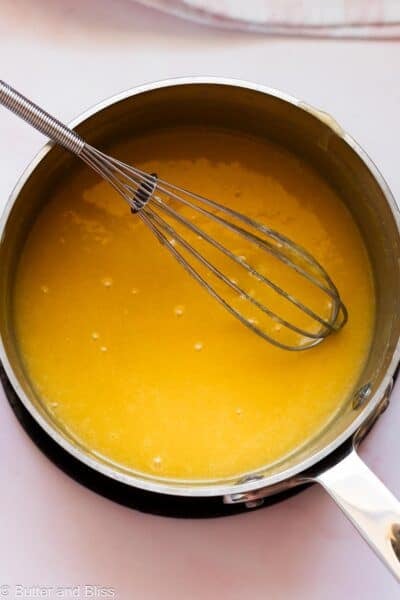 Whisked lemon curd in a saucepan.