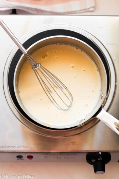 Light stage of lemon curd in saucepan.