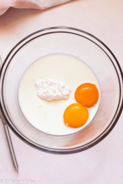 Egg yolks, corn starch and milk in a mixing bowl.
