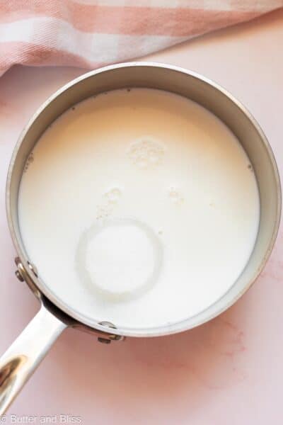 Milk and sugar added to a saucepan.
