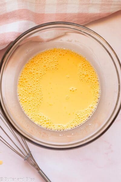 Egg yolks mixed with corn strach in a mixing bowl.