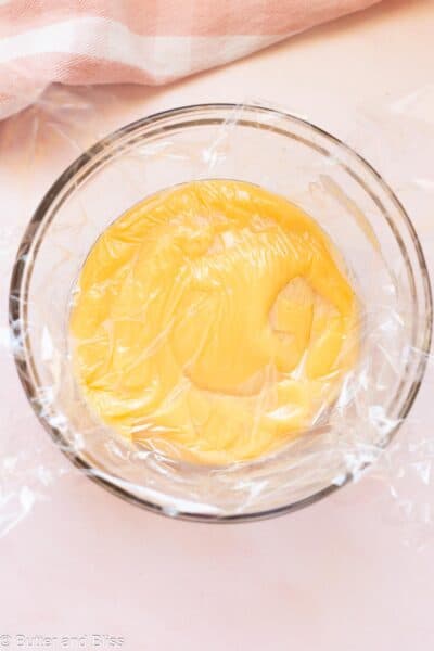 Pastry cream covered with a piece of plastic wrap.