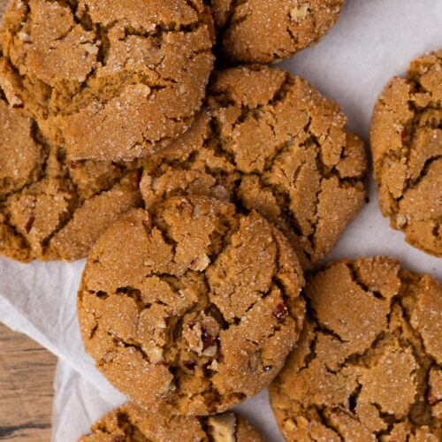 Small batch of pecan brown sugar cookies piled on a table.