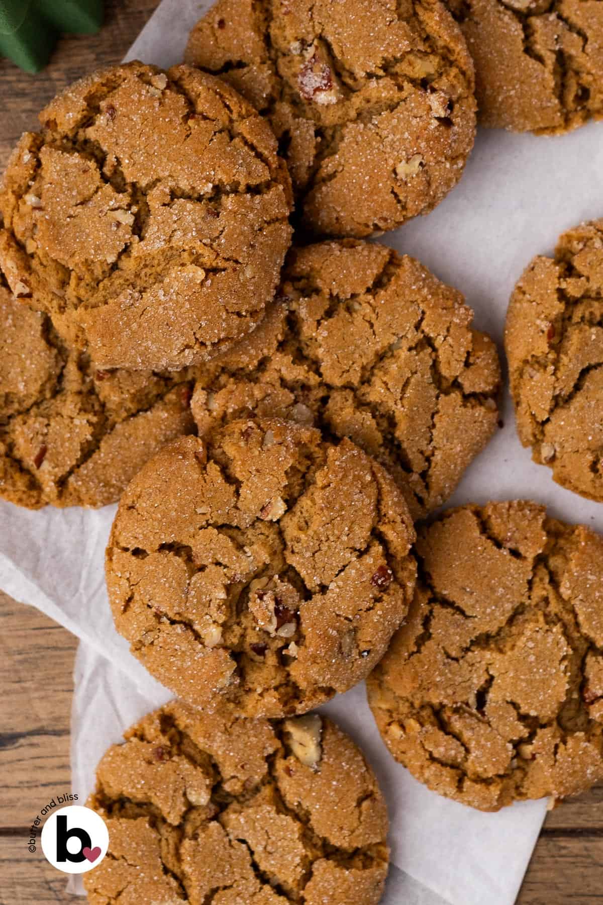Small batch of pecan brown sugar cookies piled on a table.