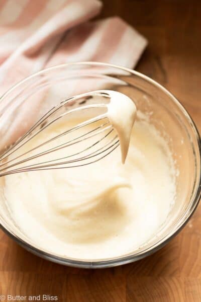 Fluffy egg white whipped to soft peaks in a mixing bowl.