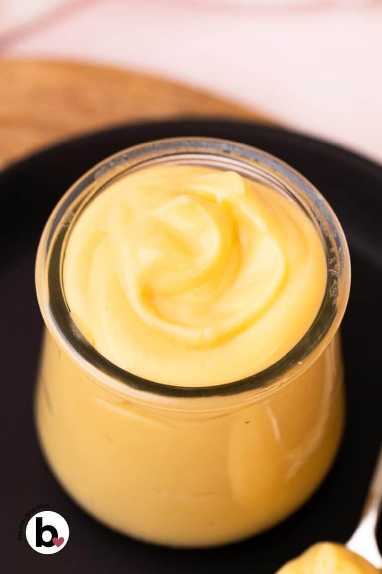 Silky vanilla pastry cream swirled into a small glass jar.