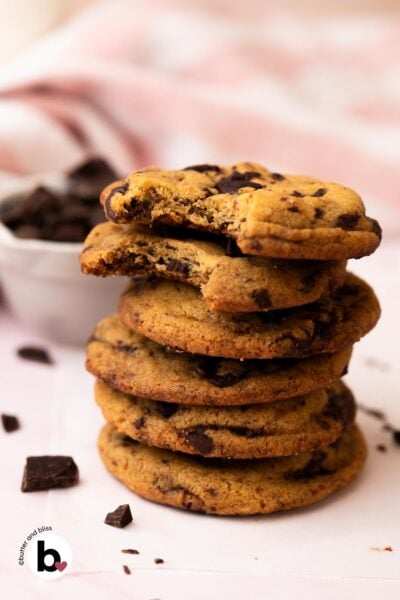 A stack of chewy small batch brown butter chocolate chip cookies on a table.
