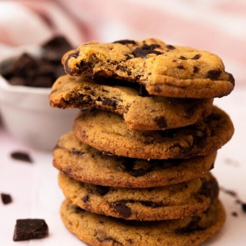 A stack of chewy small batch brown butter chocolate chip cookies on a table.