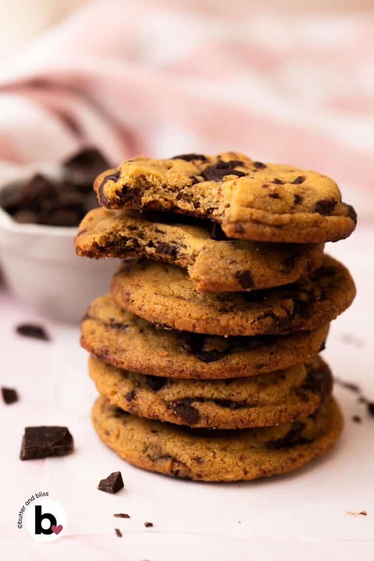 A stack of chewy small batch brown butter chocolate chip cookies on a table.
