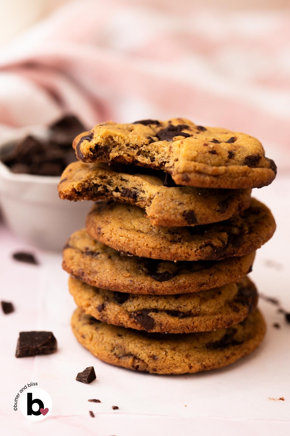 A stack of chewy small batch brown butter chocolate chip cookies on a table.