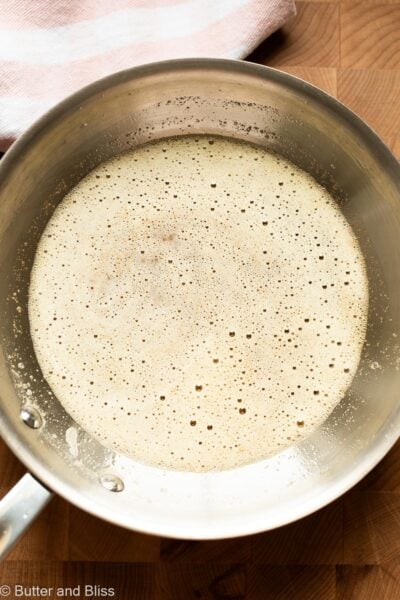 Foamy stage of brown butter in a small skillet.