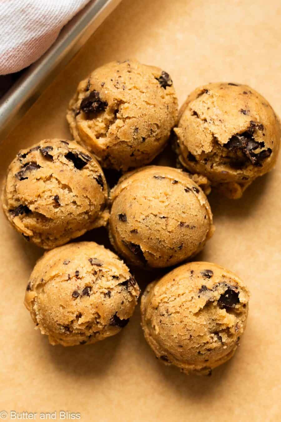 Small batch of brown butter chocolate chip cookie dough balls on a baking sheet.