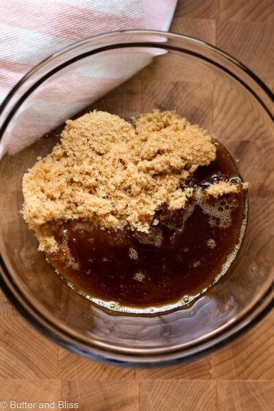 Sugar and brown butter in a mixing bowl.
