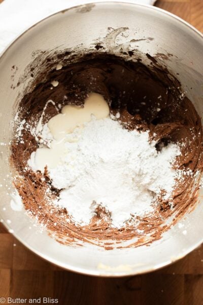 Making chocolate buttercream in a mixing bowl.