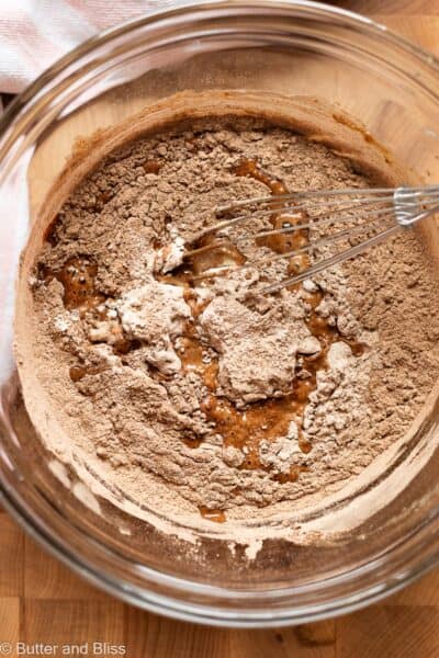Chocolate cupcake dry ingredients being combined with wet ingredients.