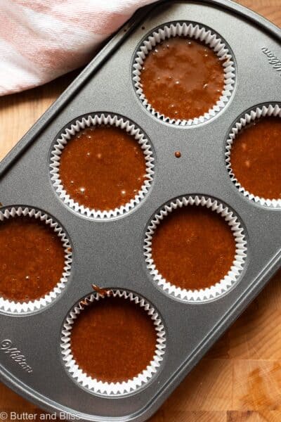 Chocolate cupcake batter in cupcake pan ready to be baked.