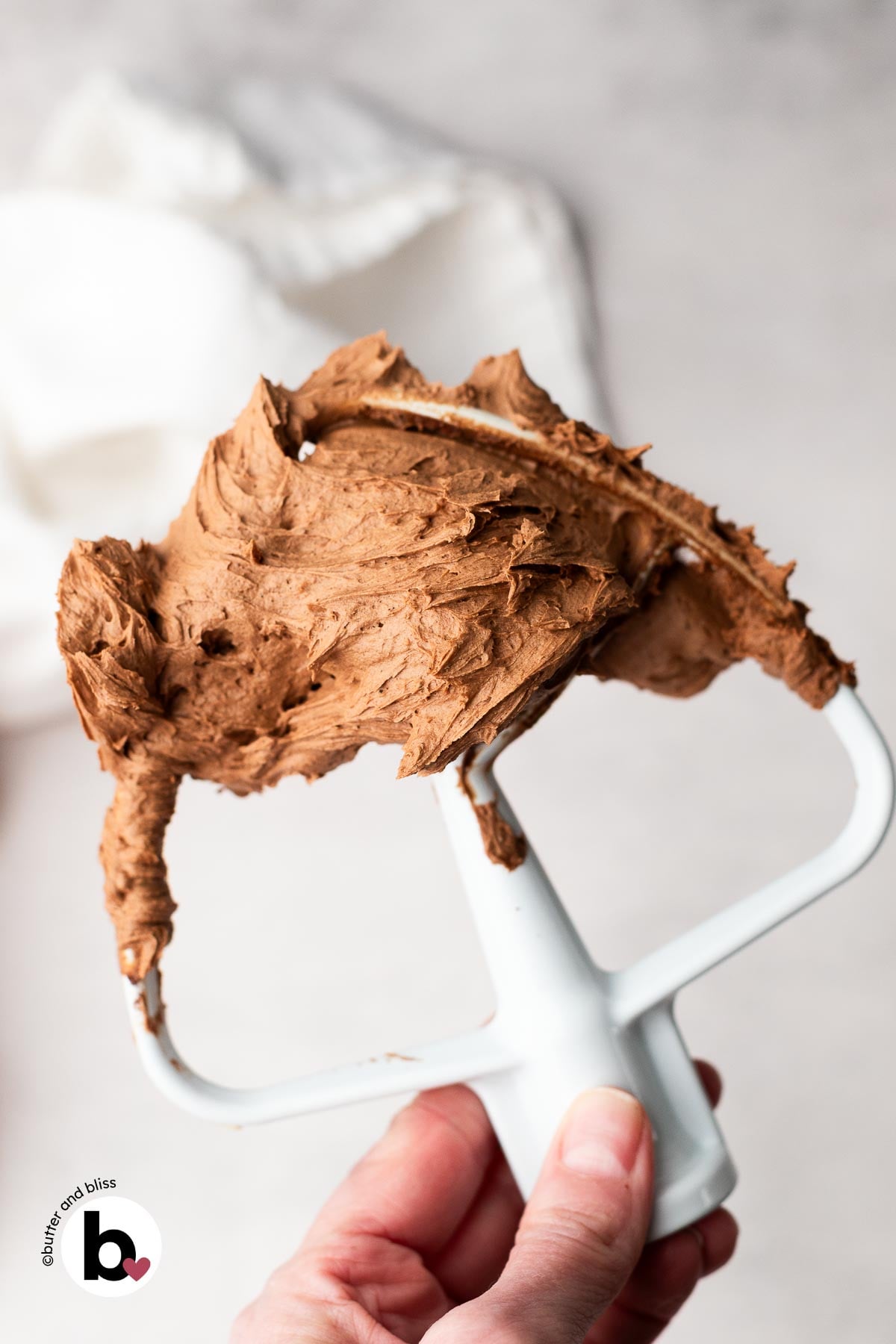 Fluffy chocolate buttercream on a mixer beater.