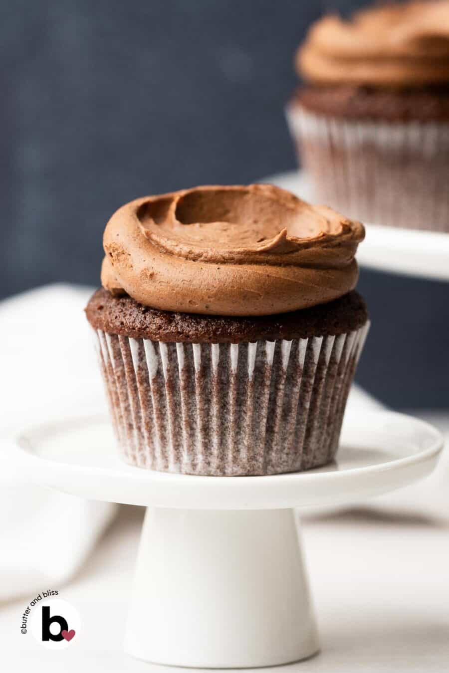 Chocolate buttercream frosting swirled onto a chocolate cupcake.