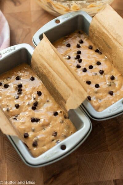 Chocolate chip banana bread batter portioned into two mini loaf pans.