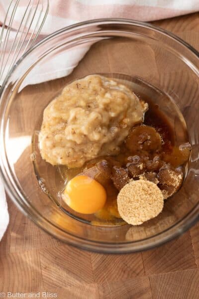 Wet ingredients for banana bread in a mixing bowl