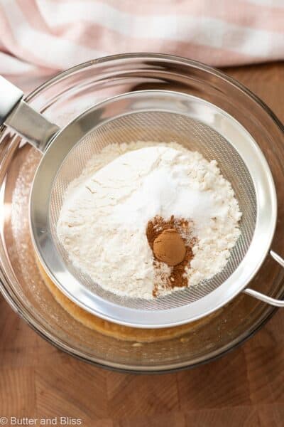 Dry ingredients for banana bread sifted into a mixing bowl.