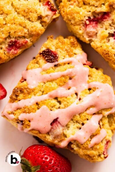 Strawberry glaze drizzled over scones.