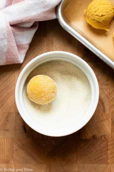 Sugar cookie dough ball rolled through sugar.