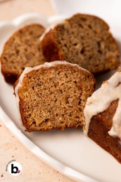Apple banana bread mini loaf cut into slices on a white plate.