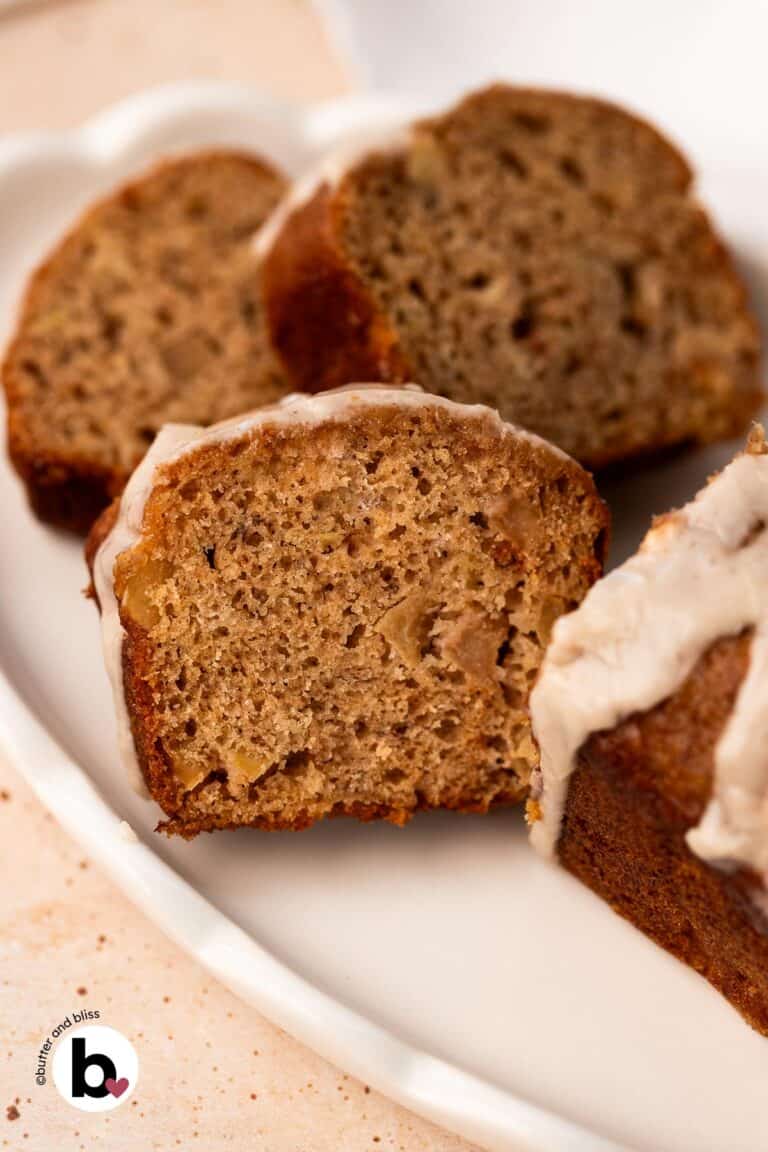 Apple banana bread mini loaf cut into slices on a white plate.