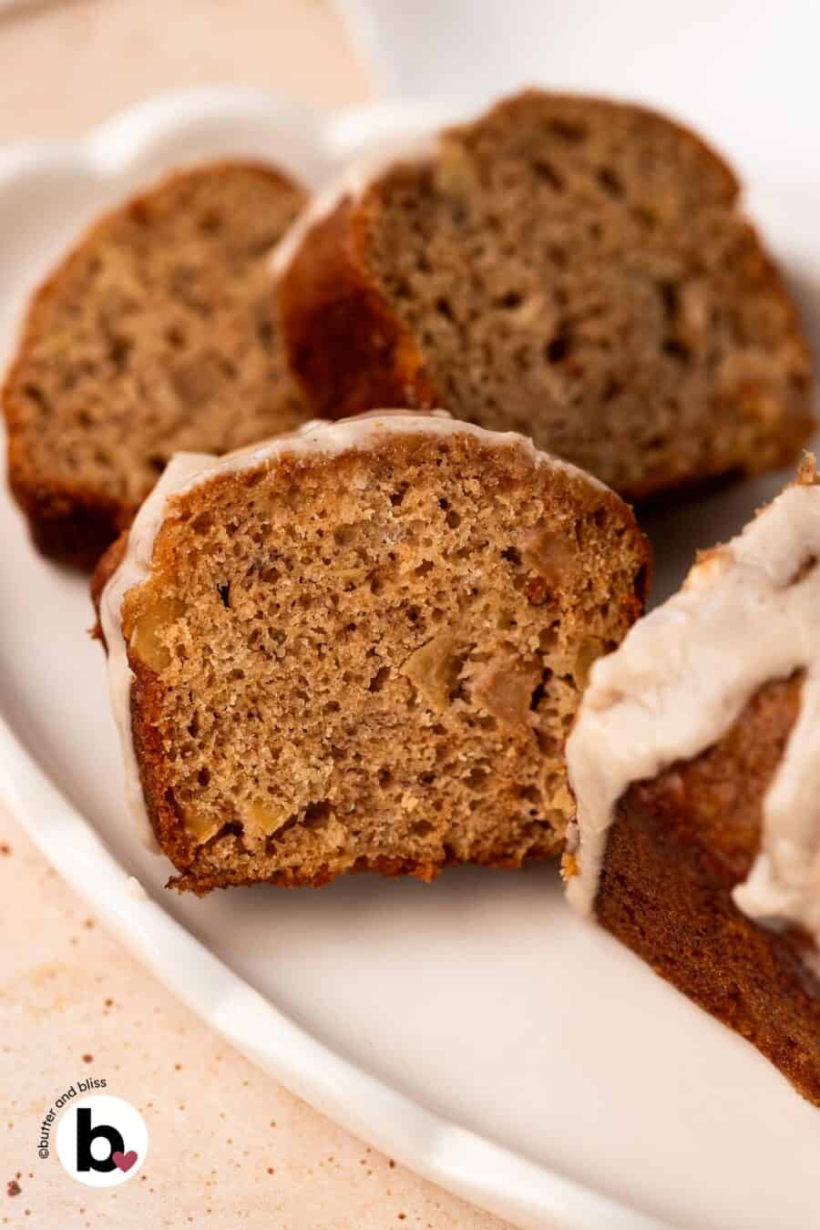 Apple banana bread mini loaf cut into slices on a white plate.