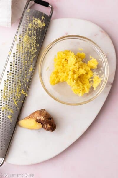 Grated fresh ginger in a small bowl.