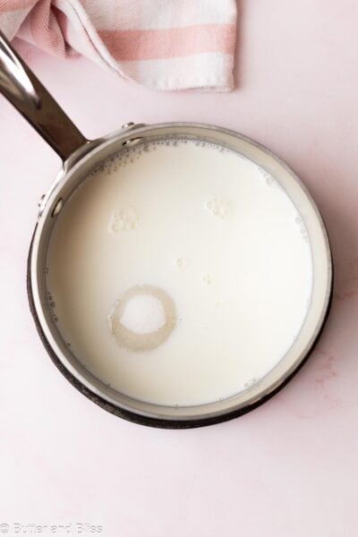 Milk and sugar in a saucepan.