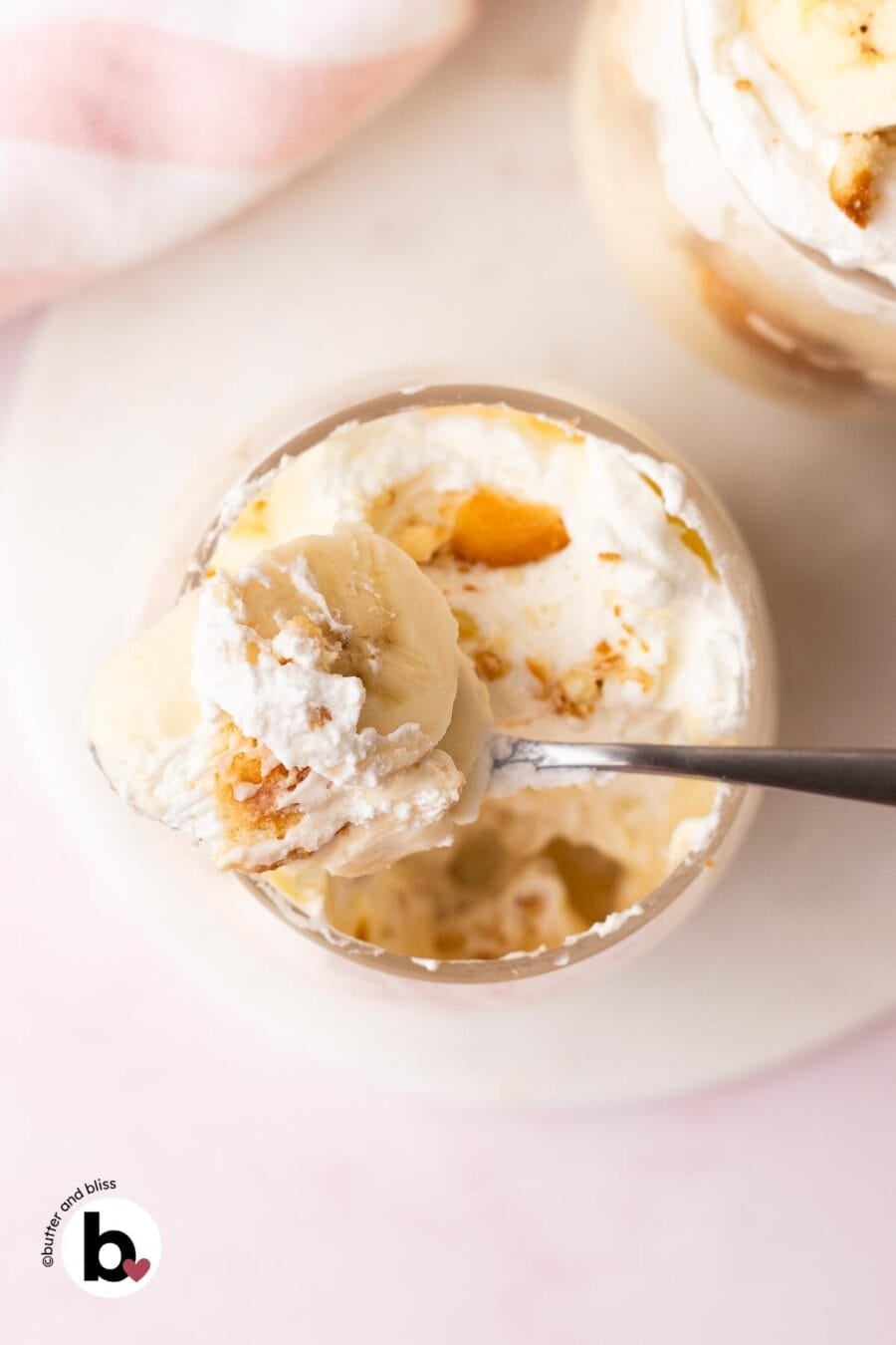 Creamy banana pudding on a spoon with a single banana slice.
