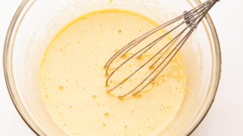 Egg and sugar mixed until foamy in a mixing bowl with a whisk.