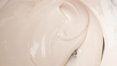 Testing the 10-second rule for royal icing, as the drip disappears into the surface.