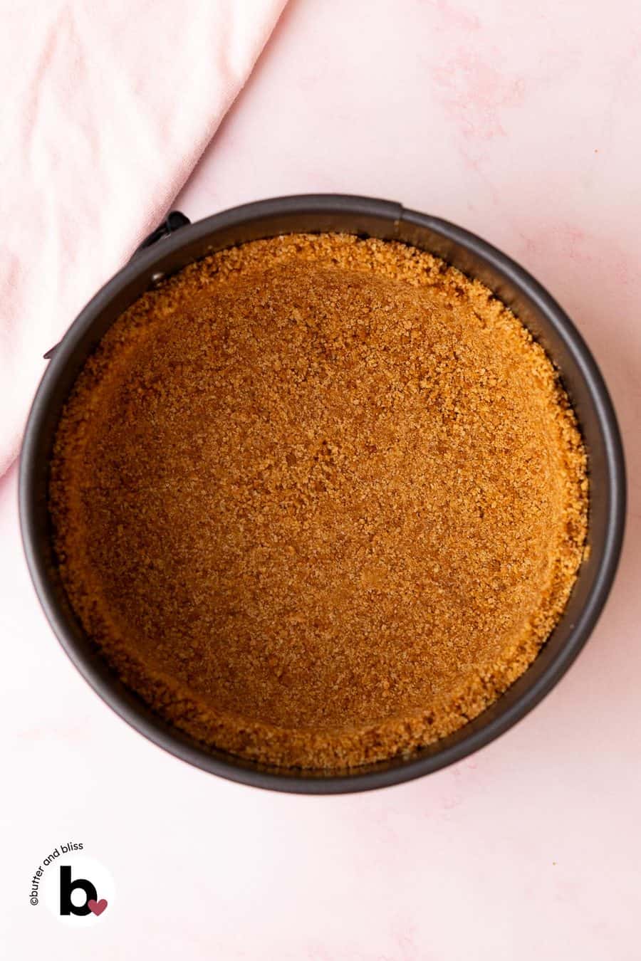 Graham cracker crust pressed into a small springform pan.