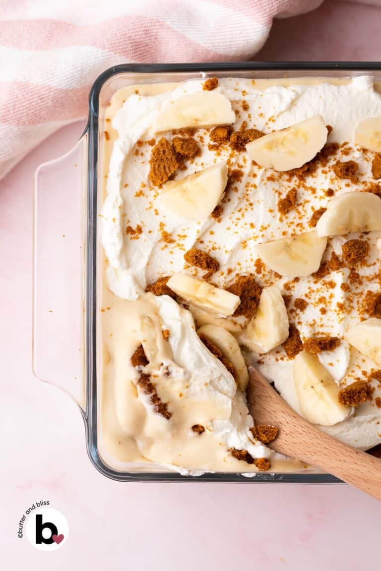 Wood spoon serving thich and creamy Biscoff banana pudding.