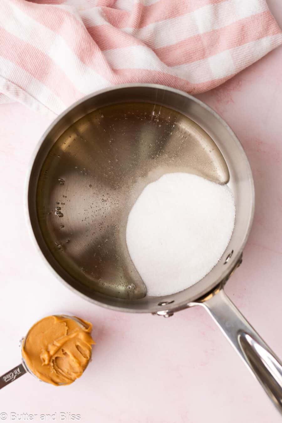 Corn syrup and sugar in a small saucepan, ready to be boiled.