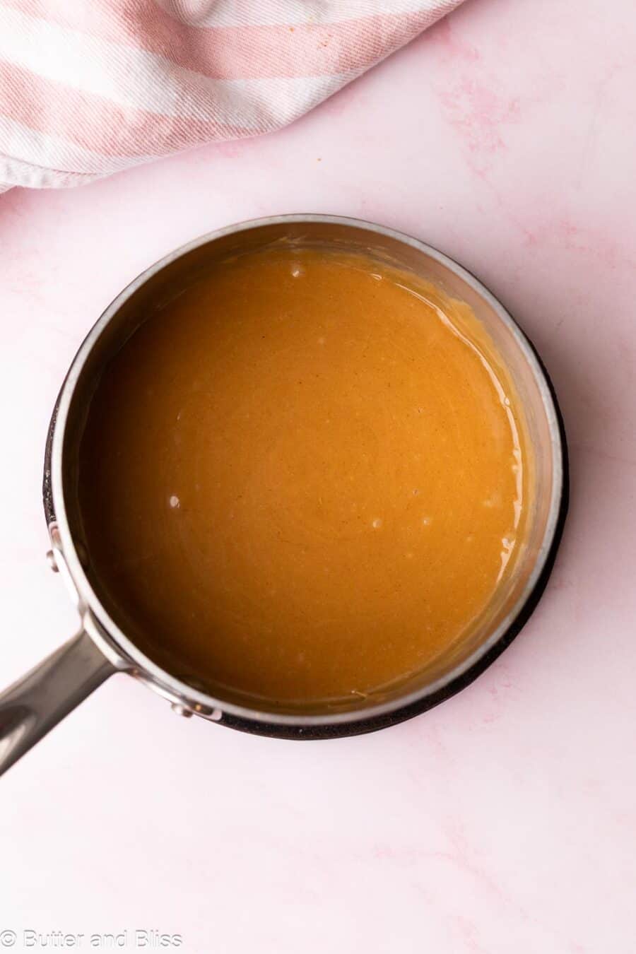 Melted peanut butter sugar syrup in a small saucepan.