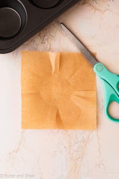 Square piece of parchment paper cut to make a tulip liner.